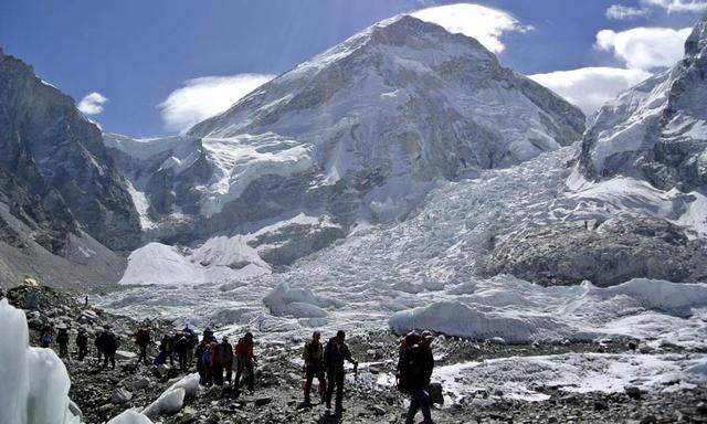 File picture shows climbers walking towards their helicopter after their Mount Everest expeditions were cancelled in Solukhumbu district, Nepal