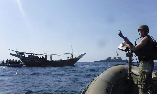The Arleigh Burke-class guided-missile destroyer USS McFaul's (DDG 74) visit, board, search and seizure team pulls alongside a Bahraini dhow during routine maritime security operations in the Arabian Gulf