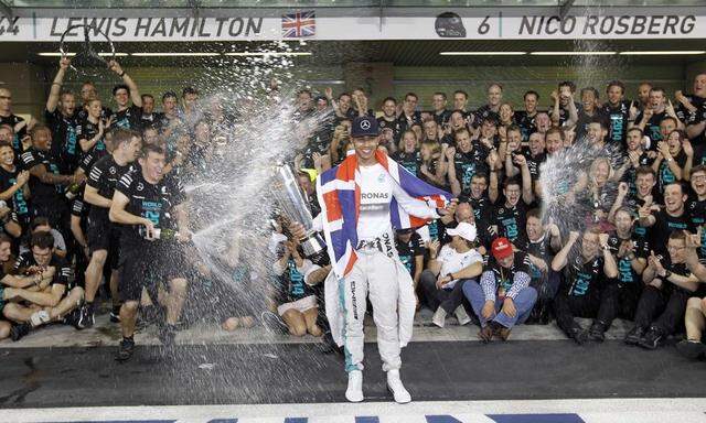 Mercedes Formula One driver Lewis Hamilton of Britain celebrates with his team after winning the Abu Dhabi F1 Grand Prix at the Yas Marina circuit in Abu Dhabi