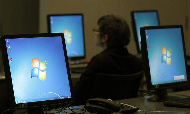 Monitors running Windows are pictured at the press center of the annual news conference of Bayer in Leverkusen