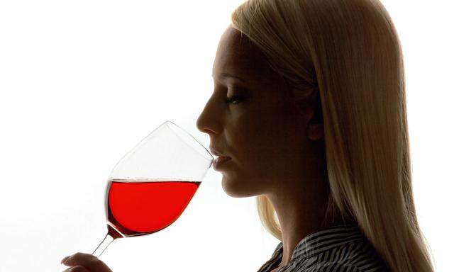 Girl tasting her frist red wine