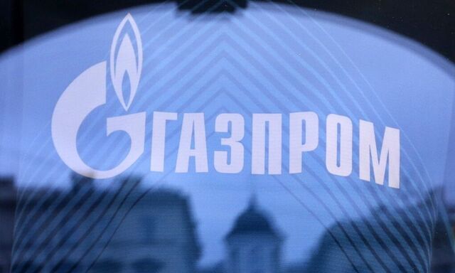 File photo of buildings reflected in a shop window, as the company logo of Russian natural gas producer Gazprom is seen on a Zenit football club T-shirt, in St. Petersburg