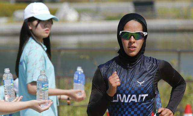 Kuwait´s I M Aljerewi, wearing a hijab, runs during the women´s triathlon competition at Songdo Central Park during the 17th Asian Games in Incheon