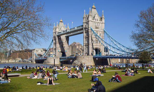 March 29, 2021, London, United Kingdom: People enjoy the sunshine in Potters Fields Park next to Tower Bridge in London.