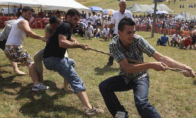 Men participate in a 'rope tow' event, also known as tug-of-war, during the Rugova Traditional Games, southwestern Kosovo August 4, 2013