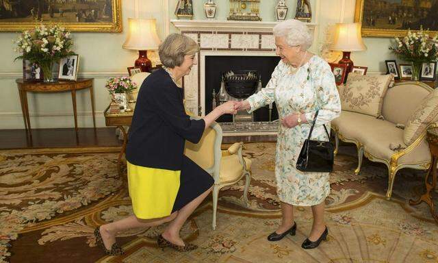 Britain's Queen Elizabeth welcomes Theresa May at the start of an audience in Buckingham Palace, where she invited her to become Prime Minister, in London