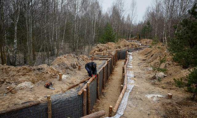 Ein Arbeiter baut einen Graben als Teil eines Systems neuer Befestigungslinien in der Nähe der russischen Grenze in der Region Tschernihiw