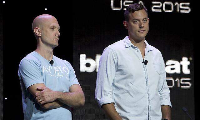 Charlie Miller (L) and Chris Valasek wait to give a briefing during the Black Hat USA 2015 cybersecurity conference in Las Vegas