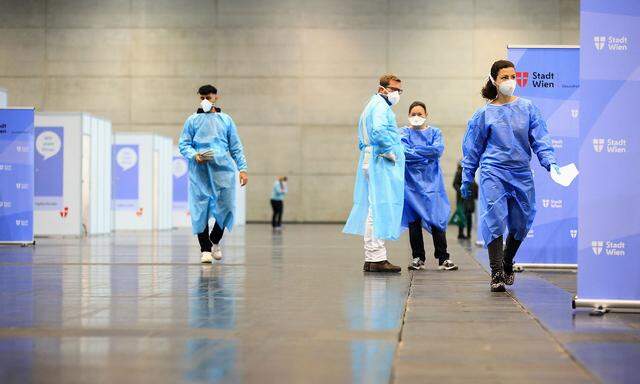 Medical workers wait at a COVID-19 vaccination station during a mass vaccination programme forhealth care workers against the coronavirus disease in Vienna