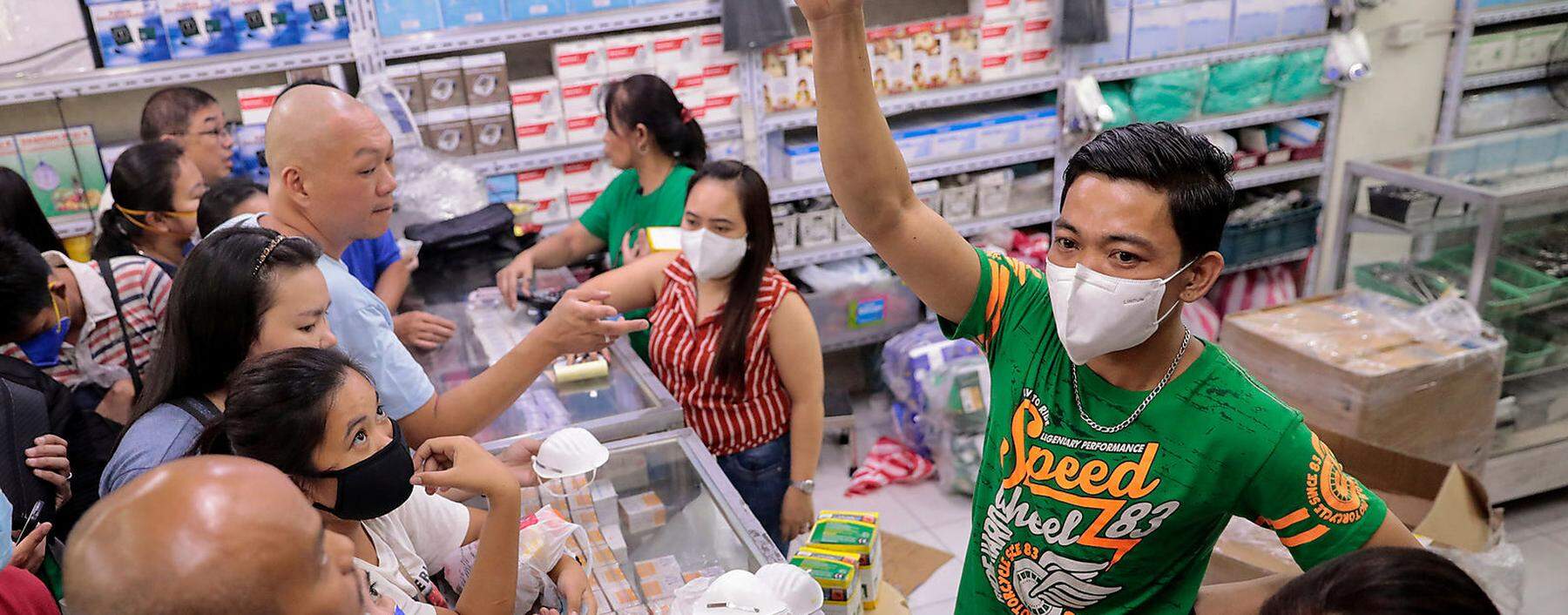 A vendor shows the only type of face mask they have available as people scramble to buy masks in a medical supply store a day after the Philippine government confirmed the first novel coronavirus case, in Manila