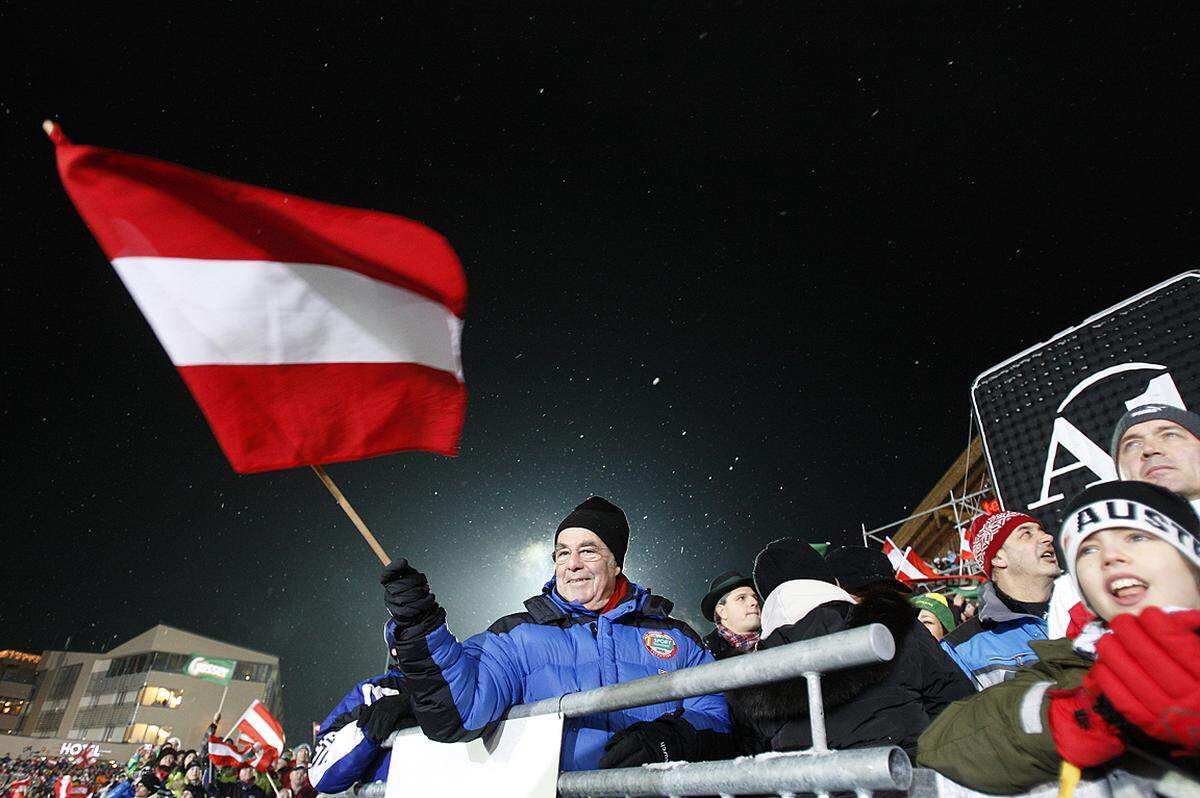 DRAGAN TATIC: Immer wieder Schladming, Steiermark, 26.1.2010 Bundespräsident Heinz Fischer schwenkt beim Nachtslalom in Schladming die Österreichfahne.