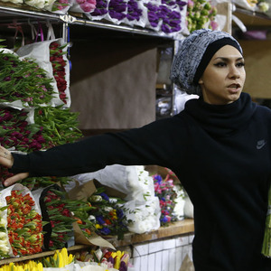 Vendor talks with customer ahead of International Women´s Day at Rizhsky flower market in Moscow