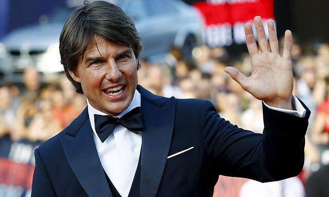 U.S. actor Cruise waves to fans upon his arrival for the world premiere of 'Mission Impossible - Rogue Nation' in Vienna