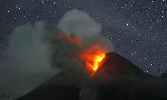 Mount Merapi volcano spews smoke as seen from Sidorejo village in Klaten