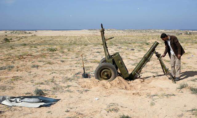 A Libya Dawn fighter adjusts a 120 mm mortar near Sirte