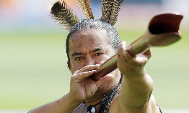 A Maori warrior welcomes the South African and United Arab Emirates teams onto the field for their Cricket World Cup match in Wellington
