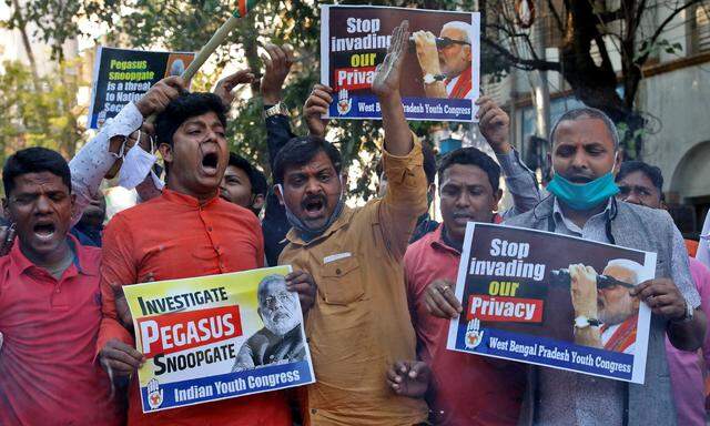 Supporters of India's main opposition Congress party hold placards as they shout slogans against India's PM Modi during a protest, in Kolkata
