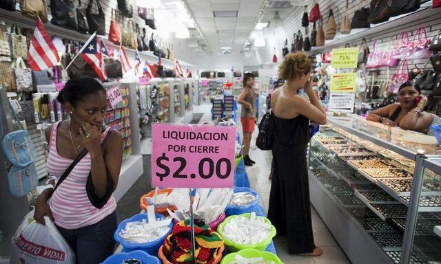 People shop in a store in San Juan