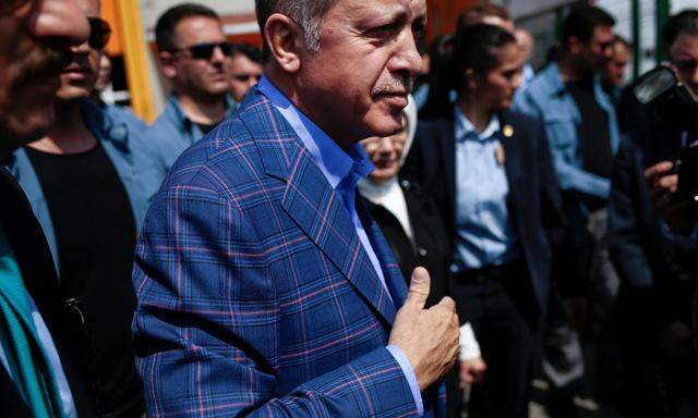 Turkish President Erdogan greets his supporters as he leaves a polling station in the Uskudar district in Istanbul