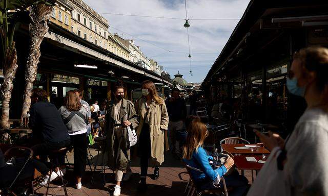 Shoppers wearing protective face masks stroll at Naschmarkt flea market as the global coronavirus disease (COVID-19) outbreak continues in Vienna