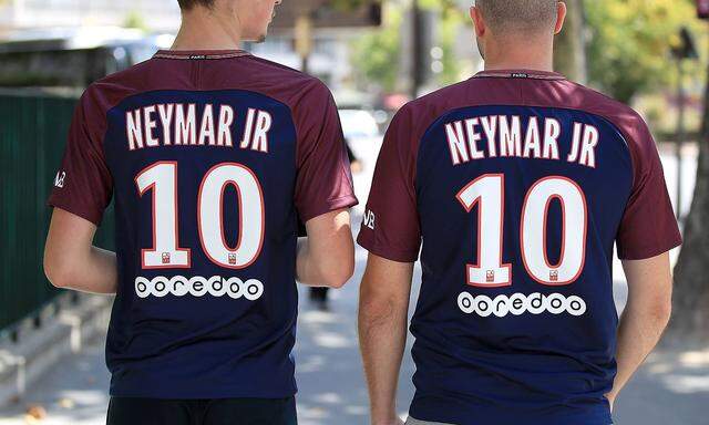 Paris Saint Germain s fans wearing shirts with new signing Neymar s name on their back prior to the