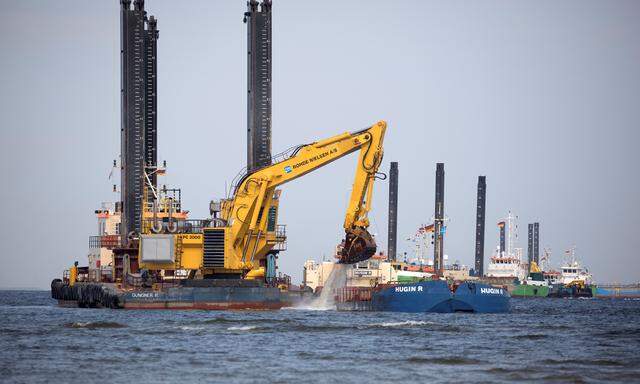 Floating excavators prepare an underwater trench for the North Stream 2 pipeline close to Lubmin