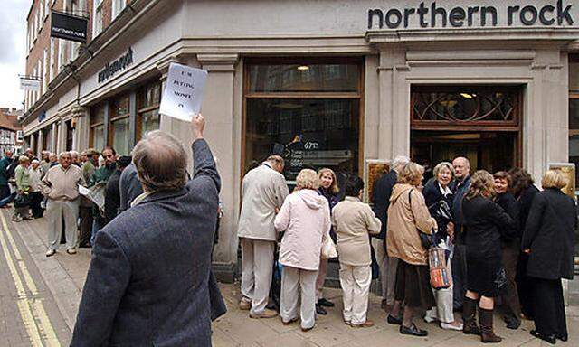 Customers queuing outside a  branch of the British  mortgage lender Northern Rock in York England , a