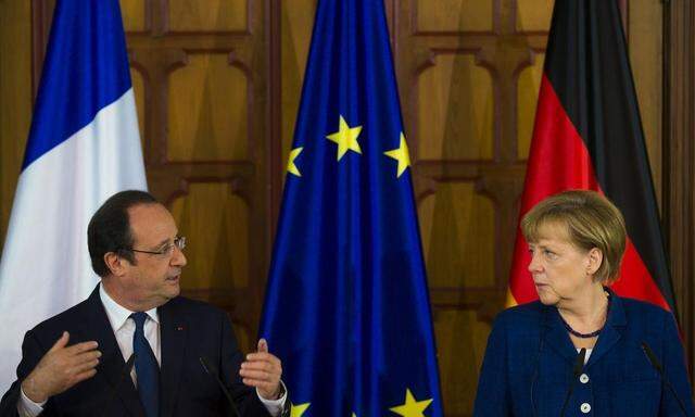 German Chancellor Merkel and French President Hollande attend a news briefing at the city hall in Stralsund