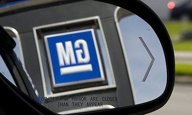 A General Motors dealership sign is reflected in a vehicles side view mirror in Montreals side view mirror in Montreal