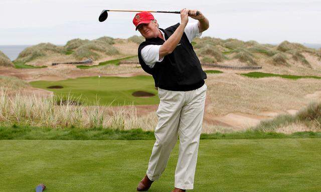 FILE PHOTO - U.S. property magnate Donald Trump practices his swing at the 13th tee of his new Trump International Golf Links course near Aberdeen