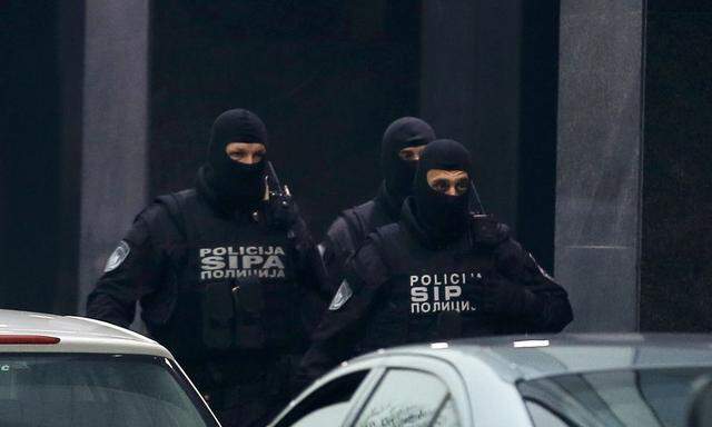 Members of Bosnia´s State Investigation and Protection Agency stand outside the buliding of Dnevni Avaz newspaper in Sarajevo