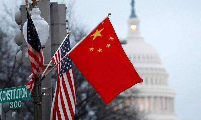 FILE PHOTO: The People's Republic of China flag and the U.S. Stars and Stripes fly on a lamp post Pennsylvania in Washington