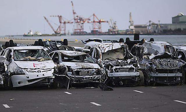 FILE - In this March 28, 2011 file photo, new vehicles damaged by the March 11 tsunami waters sit lin