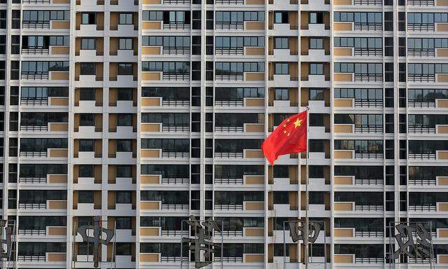 FILE PHOTO: Chinese flag flutters in front of a residential building under construction in Huaian