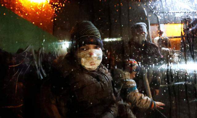 A child is seen inside a bus arranged to evacuate local residents, in Donetsk