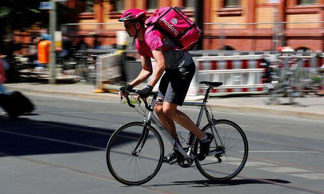 FILE PHOTO: A Foodora delivery cyclist poses on a street in Berlin