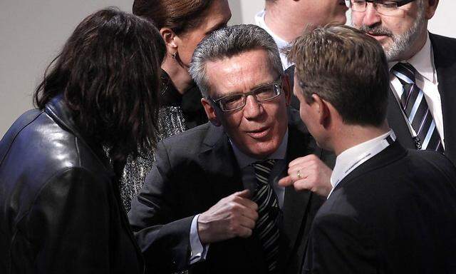 German Interior Minister Maiziere talks to Malmstroem, European Union Commissioner for Home Affairs during opening of 50th Conference on Security Policy in Munich