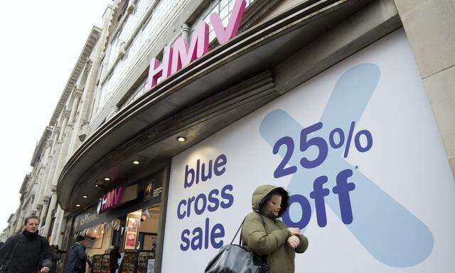 People walk past a HMV store in central London