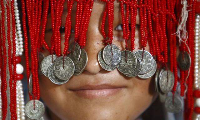 A girl participates in celebrations on the 79th birthday of the Dalai Lama in Kathmandu