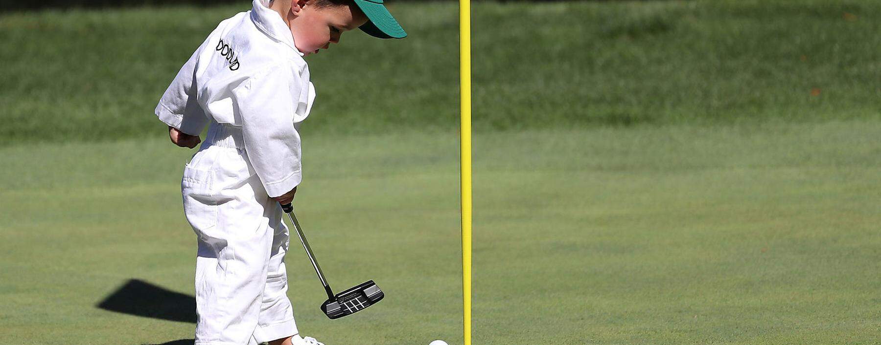 Gary Woodland's son putts on the 9th green during the 2019 Masters golf tournament's par 3 contest at the Augusta National Golf Club in Augusta, Georgia, U.S.