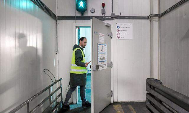 A KLM worker is entering a cold room at Amsterdam's Schiphol Airport