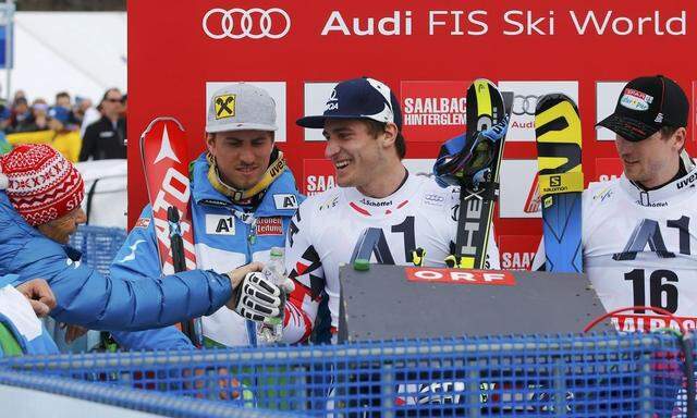 Austrian OESV skiing federation President Schroecksnadel speaks to Austrian skiers Franz Mayer and Reichelt during men's Alpine skiing World Cup downhill in Saalbach