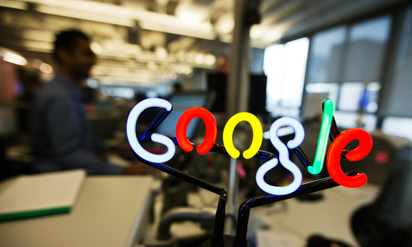 A neon Google logo is seen as employees work at the new Google office in Toronto in this file photo