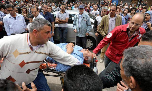 A victim is seen on a stretcher after a bomb went off at a Coptic church in Tanta