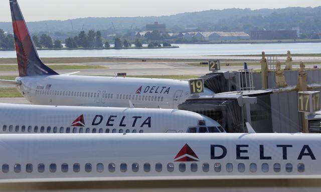 Delta Airlines planes are parked at gates after the airlines computer systems crashed leaving passengers stranded as flights were grounded globally at Ronald Reagan Washington National Airport in Washington.