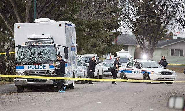 Police prepare to enter a house where five people were stabbed in the early morning hours in Calgary