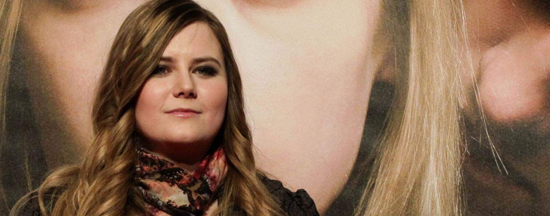 Austrian kidnap victim Natascha Kampusch poses in front of a film poster before the premiere of the film '3,096 Days' in a cinema in Vienna