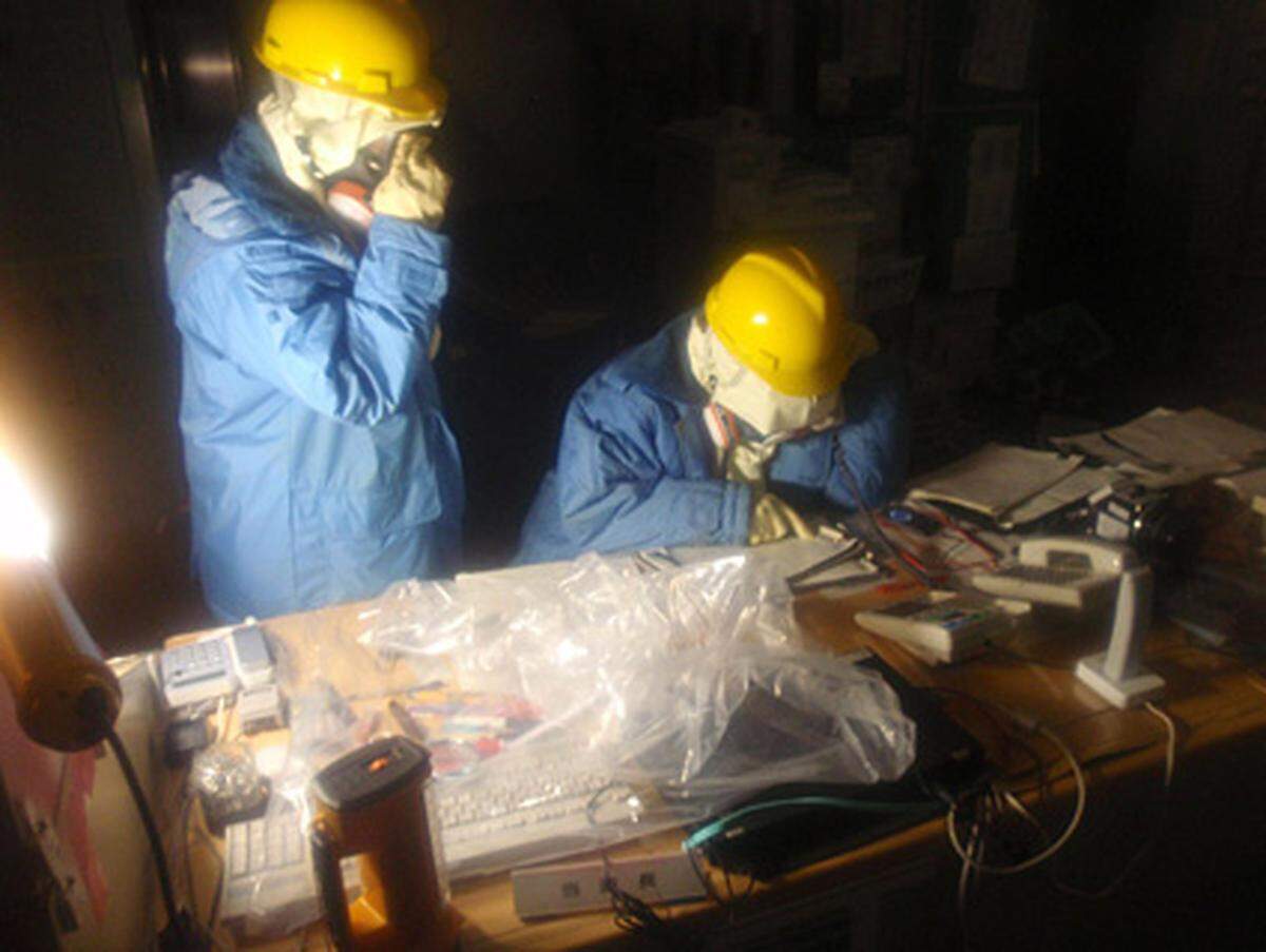 Techniker setzten ihre Vorbereitungen zur Instandsetzung des Pump- und Kühlsystems nunmehr fort, wie NHK unter Berufung auf die Betreibergesellschaft Tepco berichtete.Im Bild: Techniker notieren im Kontrollraum von Reaktor 1 den Status der Instrumente.