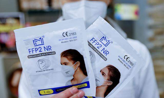 A pharmacy sales staff displays FFP2 masks in Berlin