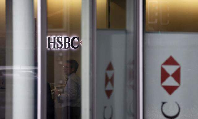 People are seen inside a HSBC Swiss branch of the bank in Geneva